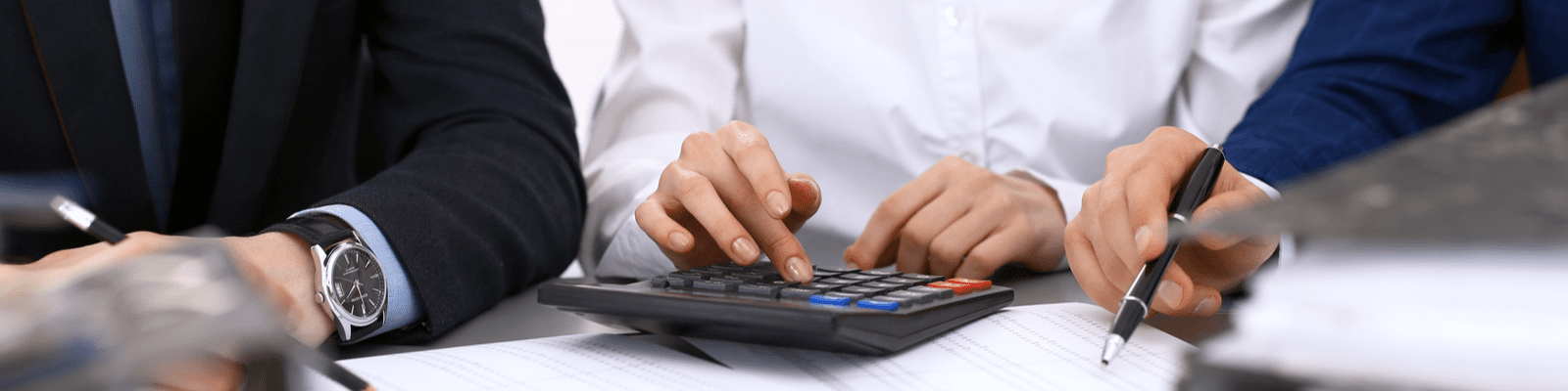 shutterstock_1089314891 hands typing on a calculator